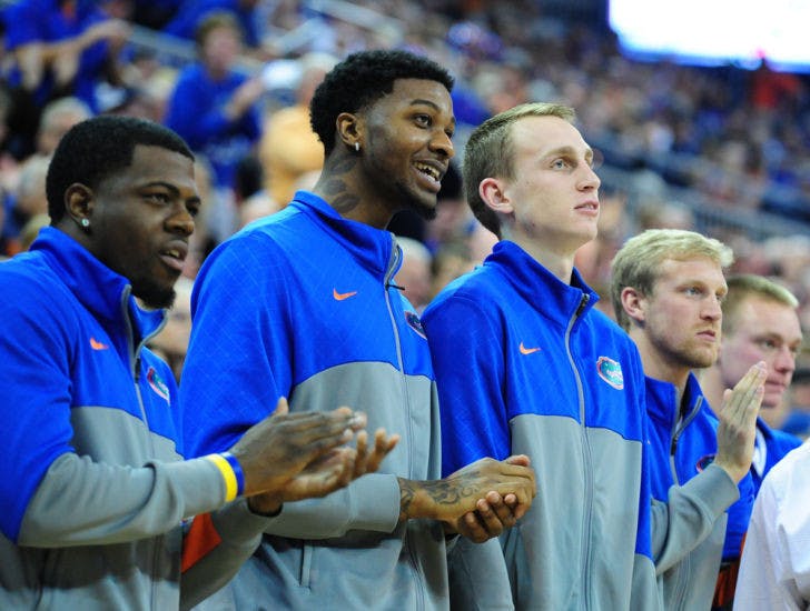 Chris Walker (middle) watches from the bench during Florida’s 74-58 win against South Carolina on Jan. 8 in the O’Connell Center. The NCAA has not cleared Walker to play for the Gators.