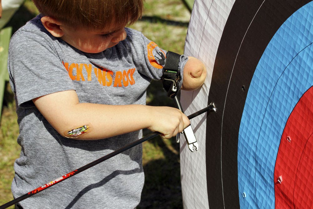 Above is a participant in Hand Camp. Children in the camp can take part in activities like archery or climbing. The camp’s motto is, “differences do not equal disability.”