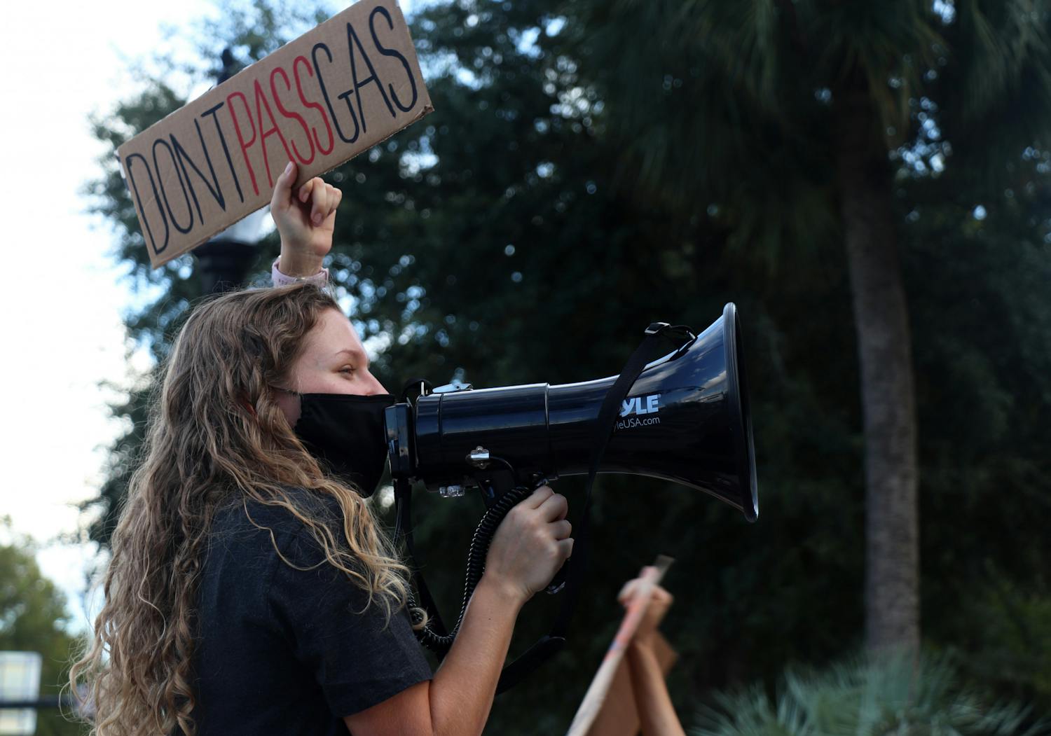 Makenzie Griffin, 22, UF zoology senior, holds a “Don’t Pass Gas” sign in protest of UF’s power plant construction during a rally at the corner of University Avenue and 13th Street on Friday, Sept. 24, 2021.  Griffin is an organizer with the Sunrise Movement, which planned the rally.