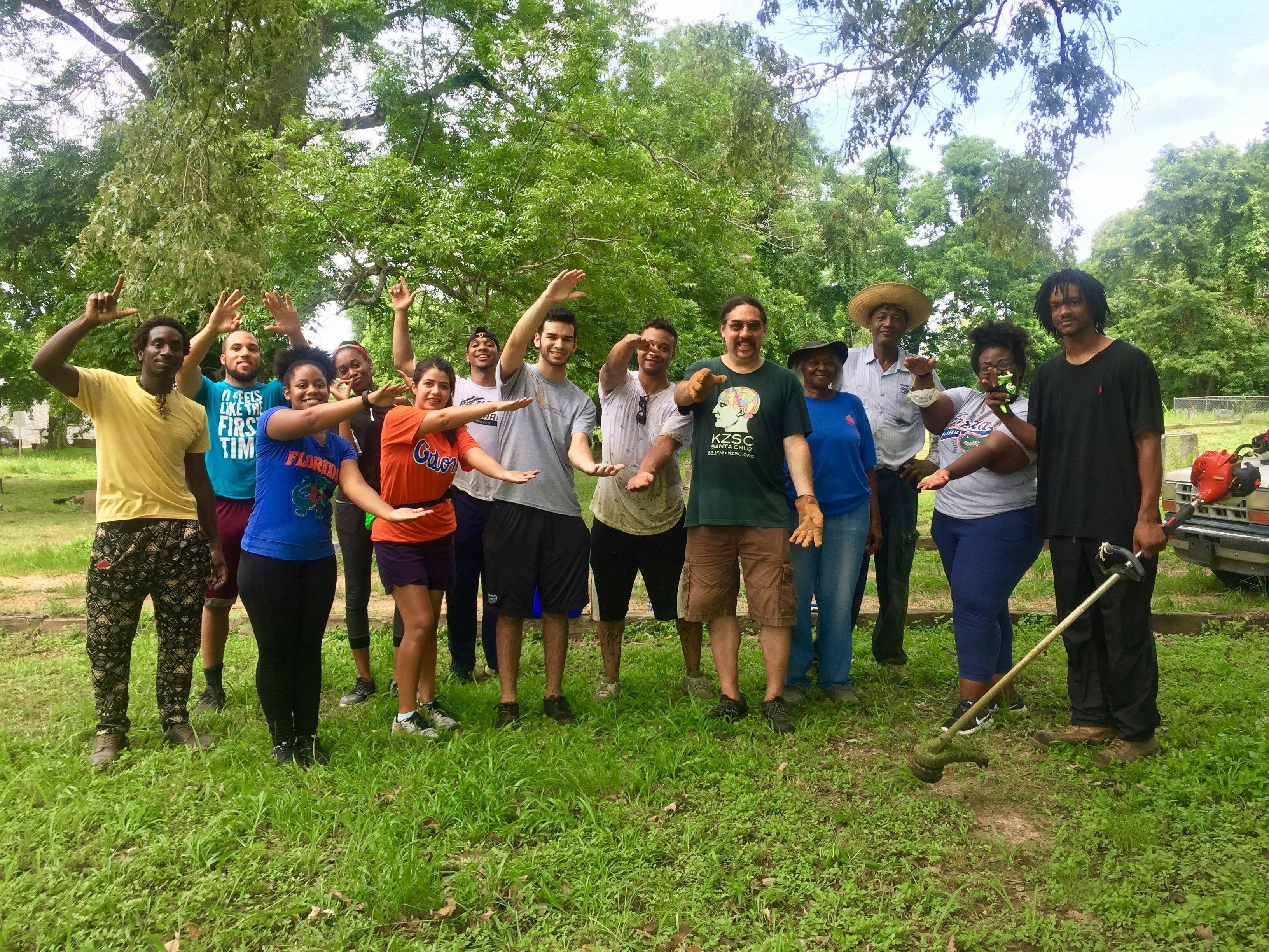 Students in the Mississippi Freedom Project help clean the Watkins Street Cemetery in the Mississippi Delta. The students borrowed weed whackers from locals to clear the area. 