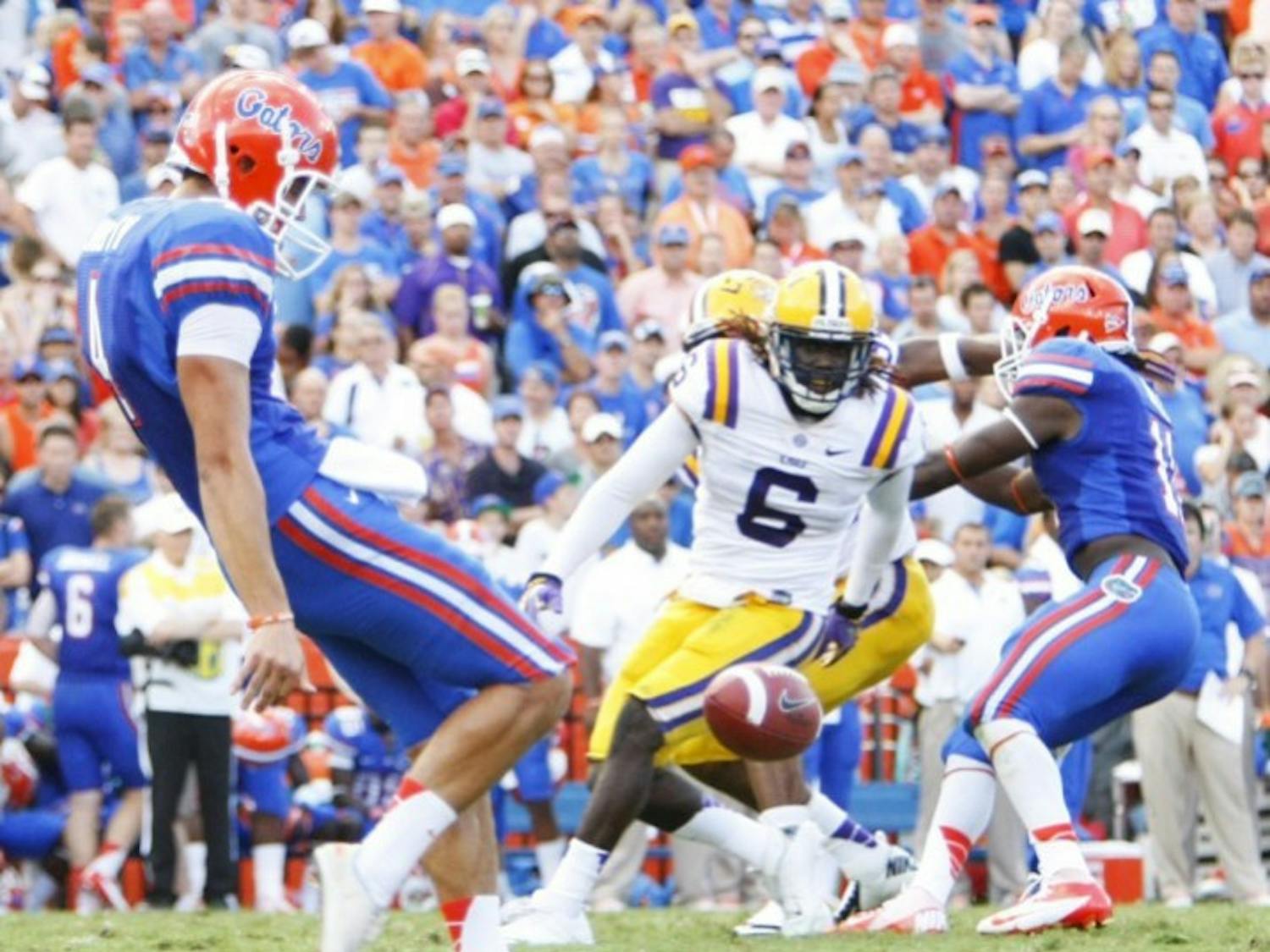 Sophomore Kyle Christy (4) punts in Florida's 14-6 victory against LSU on Saturday in Ben Hill Griffin Stadium. Christy helped UF win the field position battle by pinning LSU inside their 10-yard line three times.