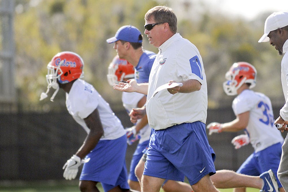 Jim McElwain instructs his players during Florida's Spring practice at the Sanders Practice Fields on March 9, 2016.