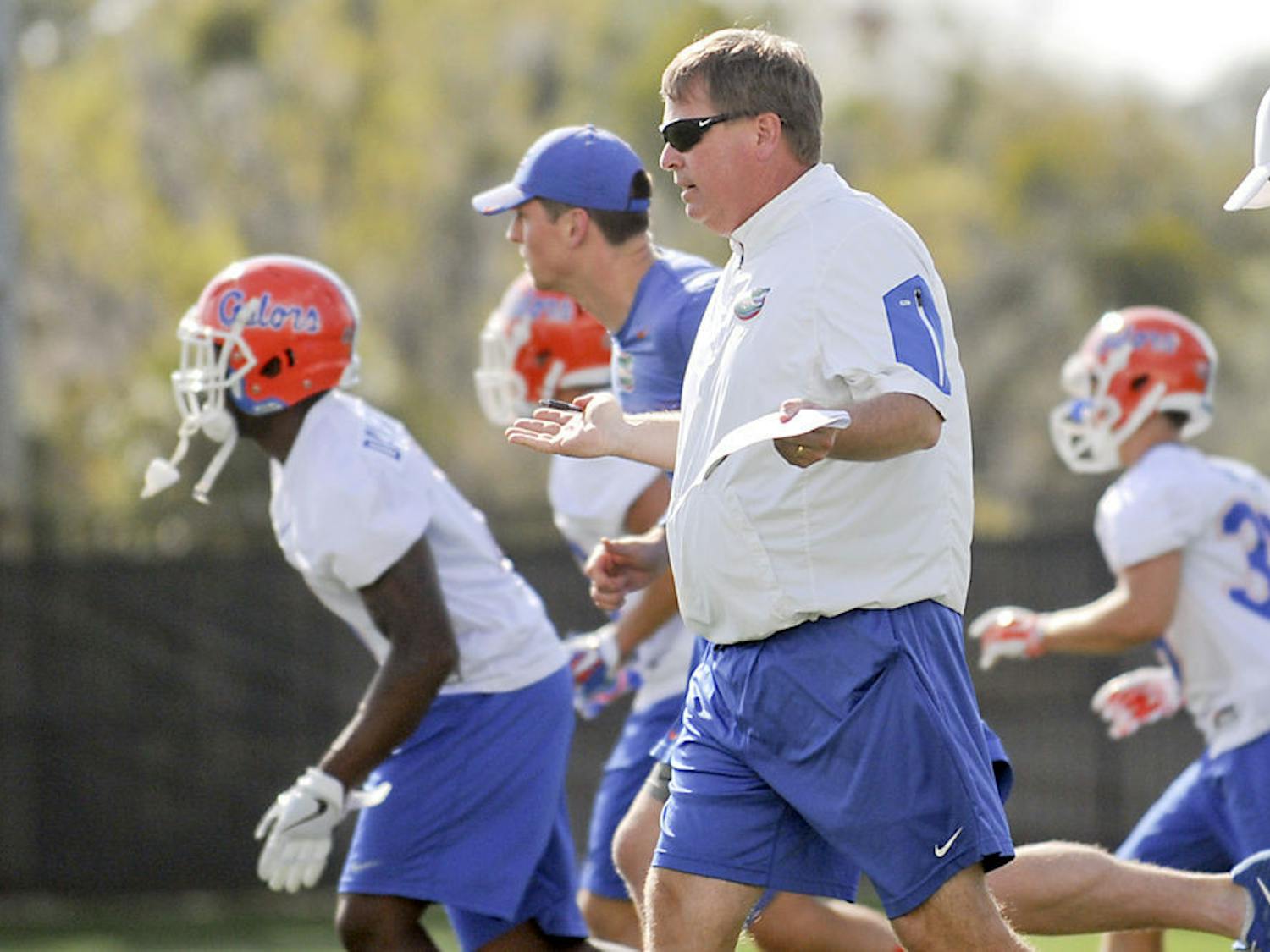 Jim McElwain instructs his players during Florida's Spring practice at the Sanders Practice Fields on March 9, 2016.