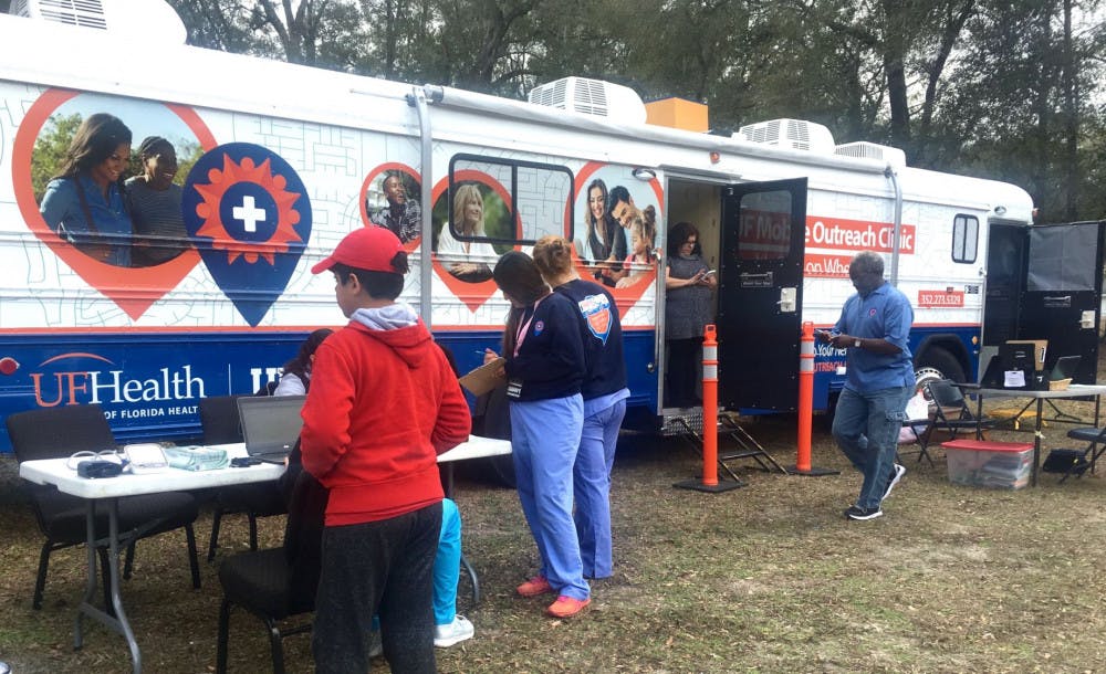 Nurses get ready to start seeing the list of patients who signed up for free clinic services on board of the UF Mobile Outreach Clinic. It was parked in front of Iglesia Hispana de Alachua, located at 13719 NW 146th Ave., in Alachua.