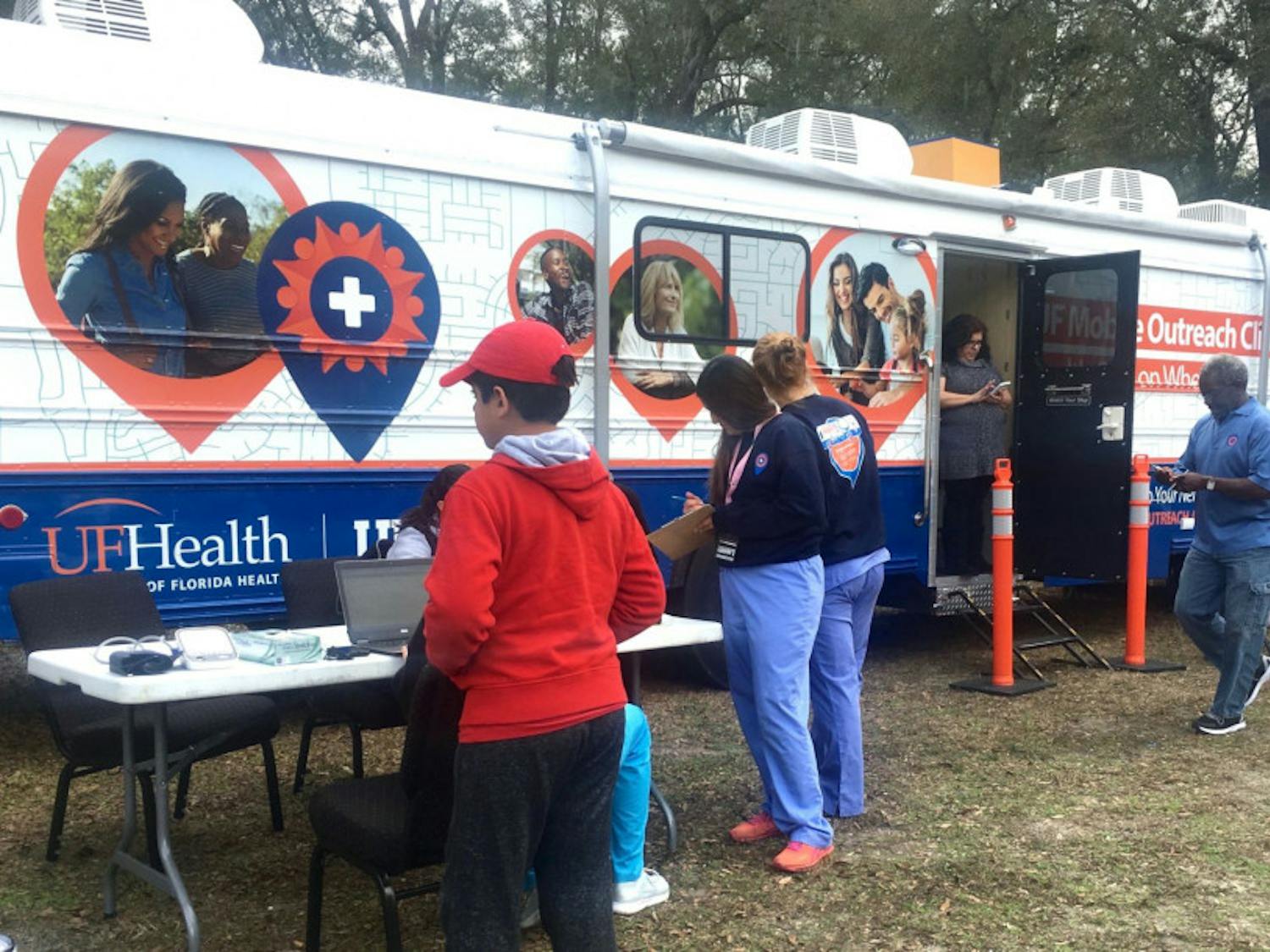 Nurses get ready to start seeing the list of patients who signed up for free clinic services on board of the UF Mobile Outreach Clinic. It was parked in front of Iglesia Hispana de Alachua, located at 13719 NW 146th Ave., in Alachua.
