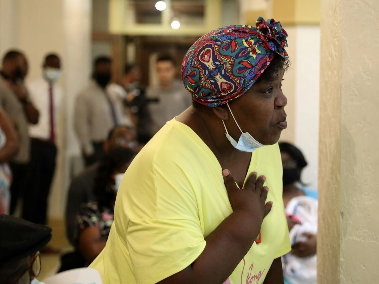 Tracy Barewell-Anderson, a Gainesville resident, holds her hand on her chest as she talks about her concerns over gun violence during the Community Call-to-Action meeting at the Thomas Center on Thursday, July 1, 2021.
