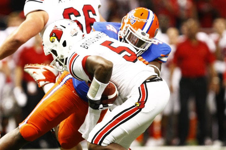 Florida defensive tackle Damien Jacobs tackles Louisville quarterback Teddy Bridgewater (5) during the Gators’ 33-23 loss to the Cardinals on Jan. 2 at the Superdome in New Orleans.