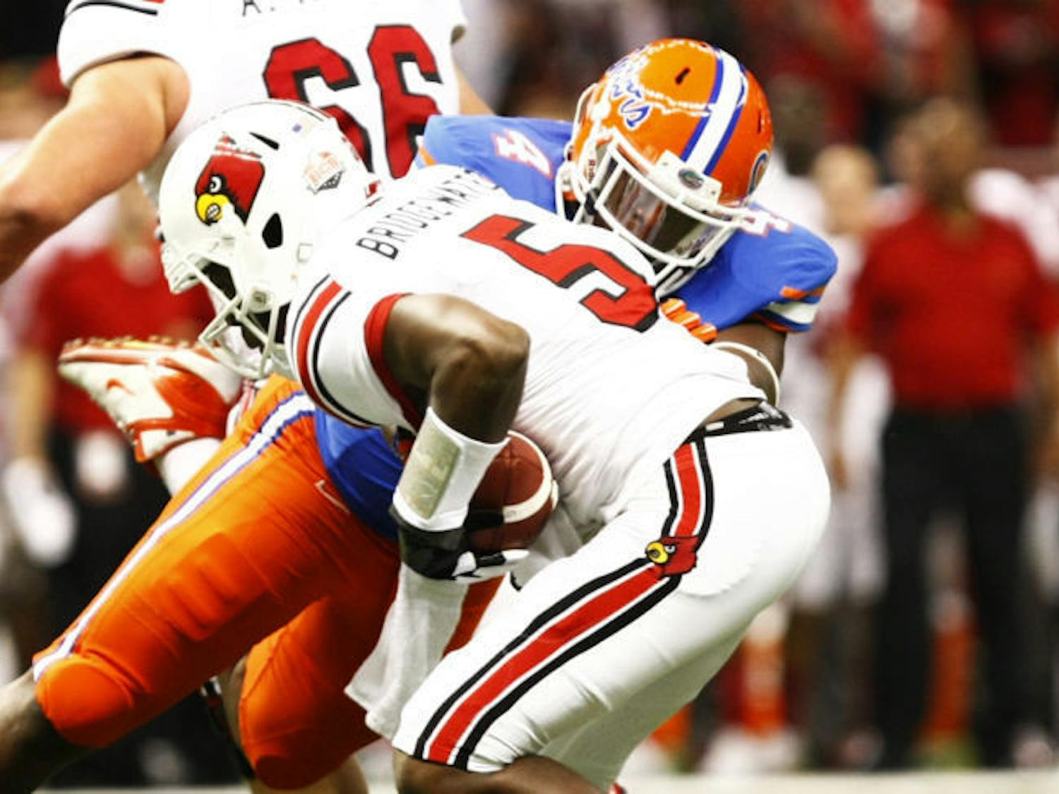 Florida defensive tackle Damien Jacobs tackles Louisville quarterback Teddy Bridgewater (5) during the Gators’ 33-23 loss to the Cardinals on Jan. 2 at the Superdome in New Orleans.