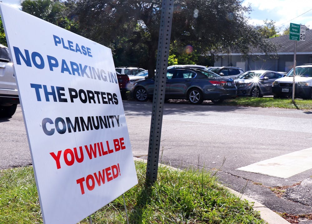 A sign is seen on the corner of Southwest Fourth Avenue and Southwest Third Street discouraging Florida Vintage Market shoppers from parking in the Porters Quarters neighborhood on Oct. 19, 2021.