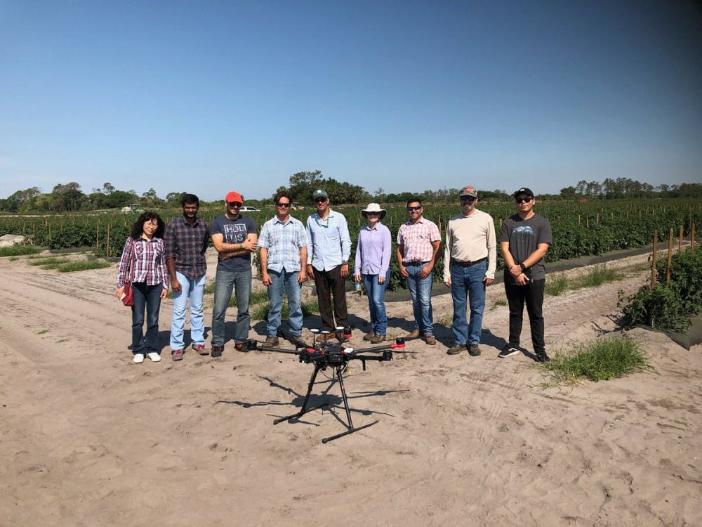 <p><span>Dr. Ampatzidis (third from left) in a drone field at the UF/IFAS Southwest Florida Research and Education Center in Immokalee.</span></p>