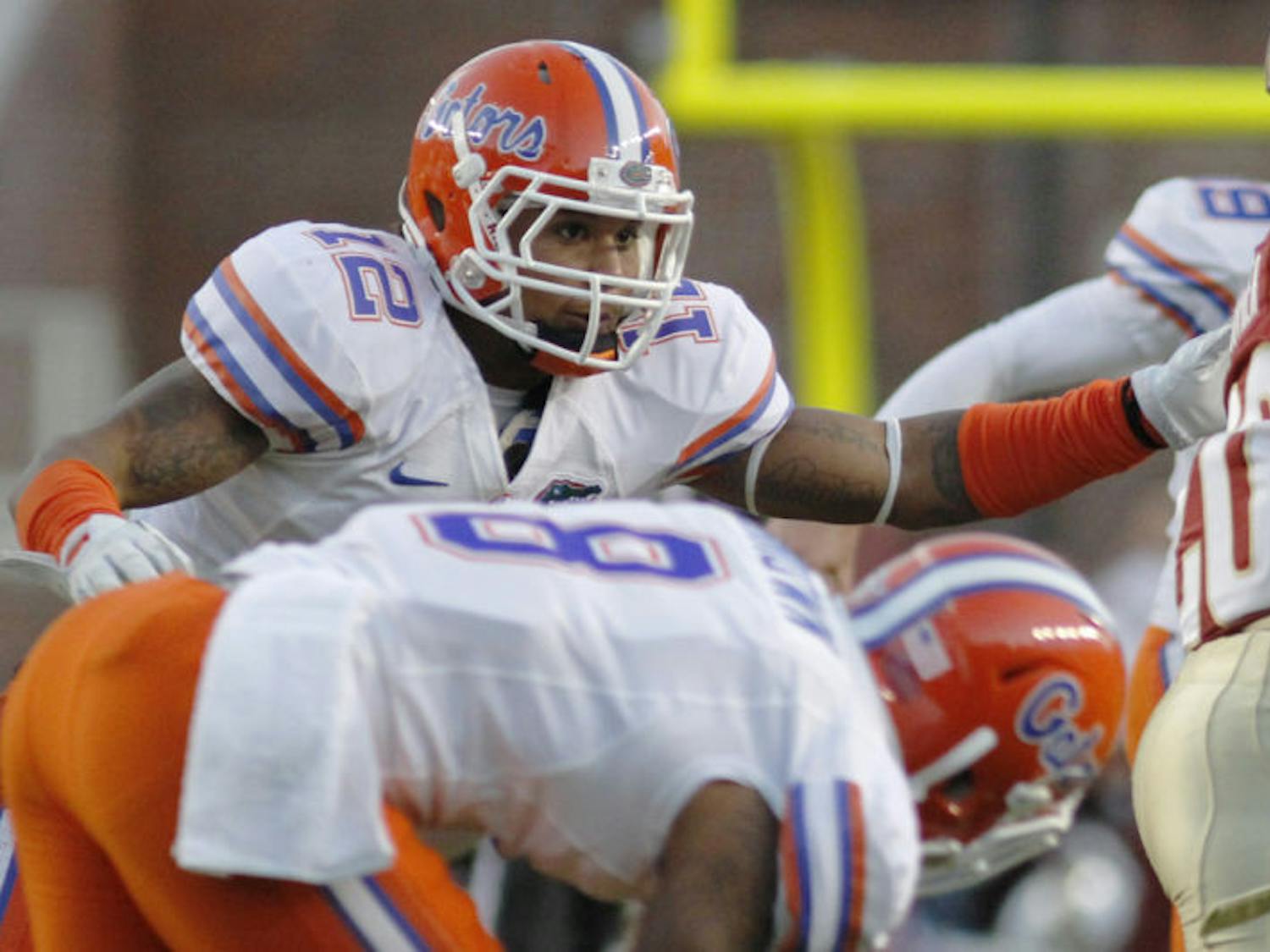 Sophomore linebacker Antonio Morrison reaches for Lamarcus Joyner during Florida’s 37-26 victory against Florida State on Nov. 24 in Doak Campbell Stadium. After sitting out the Gators’ season opener on Aug. 31 due to a suspension stemming from two offseason arrests, Morrison is listed as the backup at the Mike linebacker position for Saturday’s game against Miami.