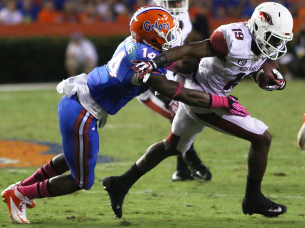 <p>Jaylen Watkins (14) tackles Arkansas wide receiver Javontee Herndon (19) during Florida’s 30-10 win against the Razorbacks on Oct. 5, 2013, in Ben Hill Griffin Stadium. Watkins was selected by the Philadelphia Eagles in the fourth round of the NFL Draft on Saturday.</p>