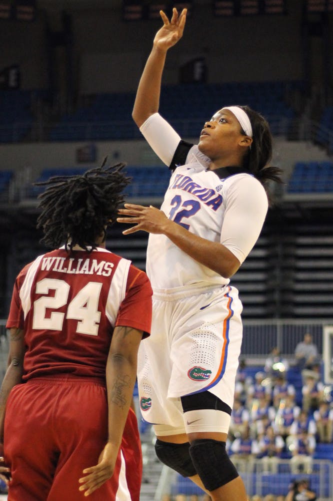 Senior forward Jennifer George attempts a shot over Arkansas forward Quistelle Williams on Feb. 28 in the O’Connell Center.
