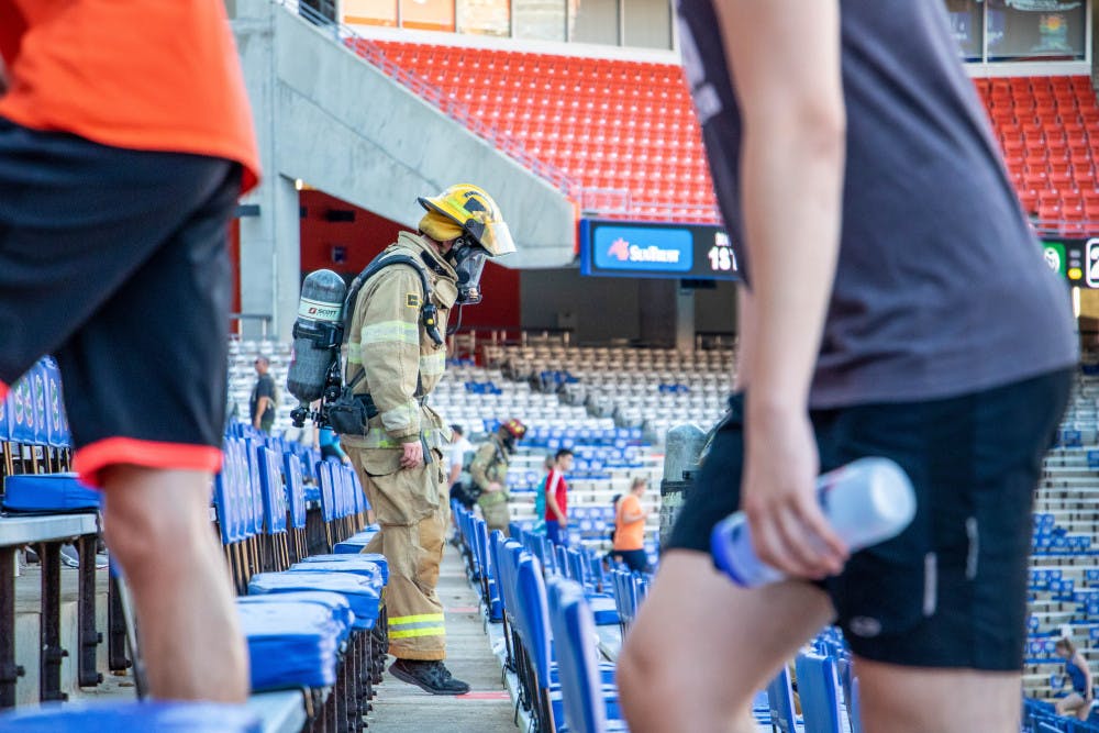 <p><span id="docs-internal-guid-5752119e-7fff-c92f-53f2-72a7bd8280ce"><span>A climber wearing "bunker gear" descends the steps during the second annual 9/11 Memorial Stair Climb at Ben Hill Griffin Stadium on Tuesday evening. More than 150 people participated in the stair climb hosted by the UF Collegiate Veterans Society. The event consisted of climbing 1,980 steps, or 11 trips up and down the stadium, to represent the amount of stairs in one of the twin towers.</span></span></p>