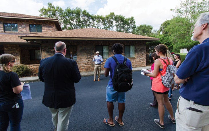 North Central Florida Central Labor Council staff member Jeremiah Tattersall speaks to a group of protesters at the office of U.S. Rep. Ted Yoho (R-Fla.) on Tuesday. The group was discussing the government shutdown.