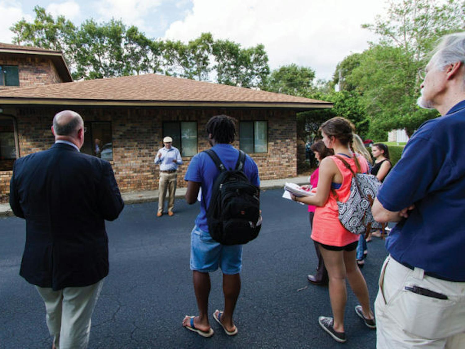 North Central Florida Central Labor Council staff member Jeremiah Tattersall speaks to a group of protesters at the office of U.S. Rep. Ted Yoho (R-Fla.) on Tuesday. The group was discussing the government shutdown.