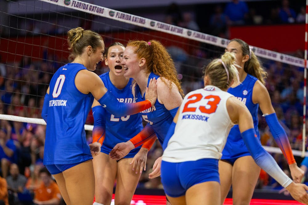 Florida Gators outside hitter AC Fitzpatrick (0) and Florida Gators setter Alexis Stucky (5) celebrate a point during the first set at the Exactech Arena at the Stephen C. O'Connell Center on Sunday, October 06, 2024.