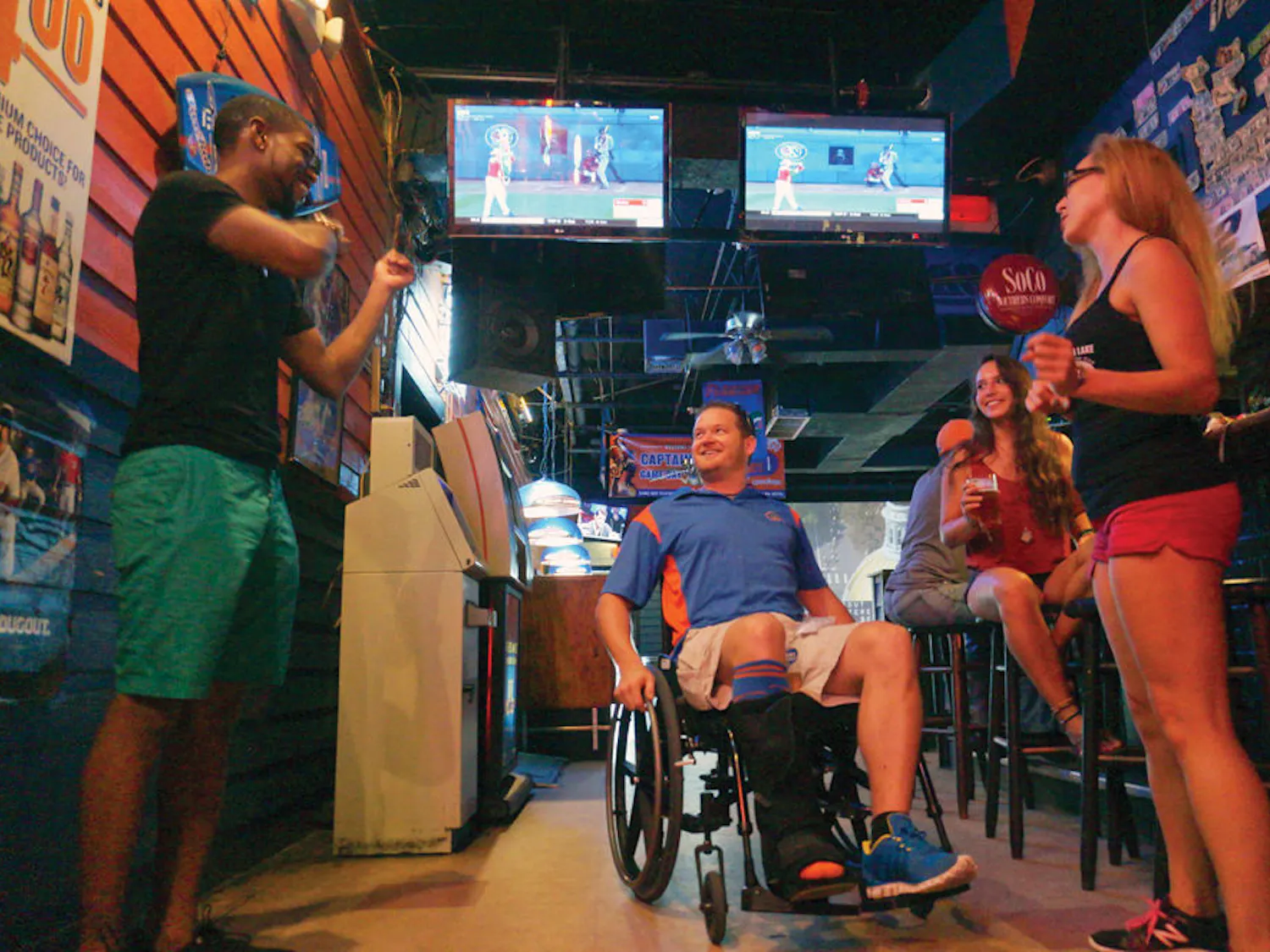 Brad Heron, piano player and owner at Rockey's Dueling Piano Bar, spent Sunday night out with his coworkers Sean Reed (left), Mayan Alvarado (middle) and Marylin Prado (right). He is one of 30 people who will participate in the Wheelchaired for a Day Challenge in Gainesville this month, which raises awareness of issues that affect the disabled community.