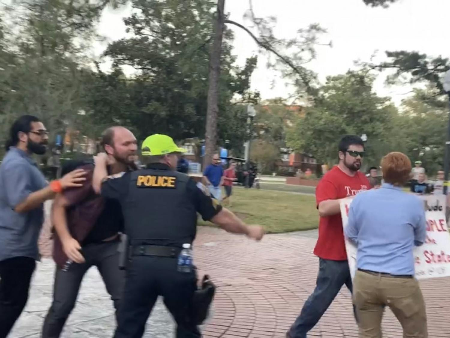 Brian Patrick Smith was outside University Auditorium Thursday night among among protestors who were protesting against Donald Trump Jr. and Kimberly Guilfoyle's speech. Richard Tate was arrested after taking Smith's "Make America Great Again" cap. 