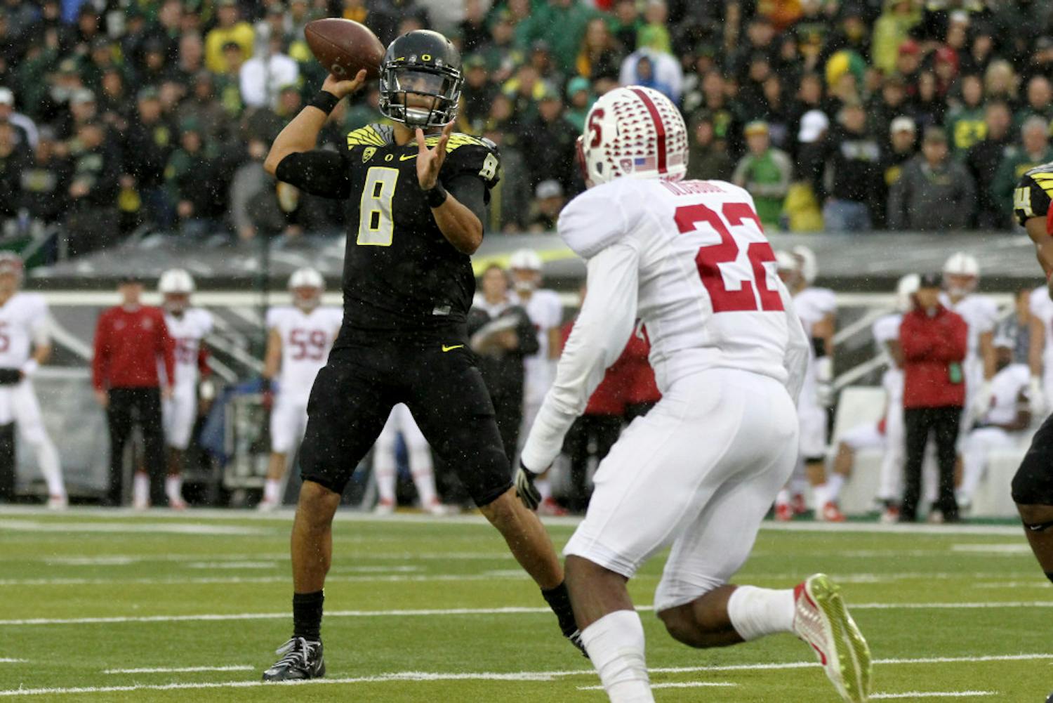 Oregon quarterback Marcus Mariota (8) looks to throw towards the end zone during the first quarter against Stanford in an NCAA college football game in Eugene, Ore., Saturday, Nov. 1, 2014. 