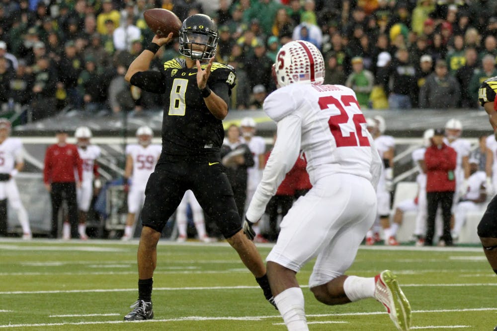 <p>Oregon quarterback Marcus Mariota (8) looks to throw towards the end zone during the first quarter against Stanford in an NCAA college football game in Eugene, Ore., Saturday, Nov. 1, 2014. </p>