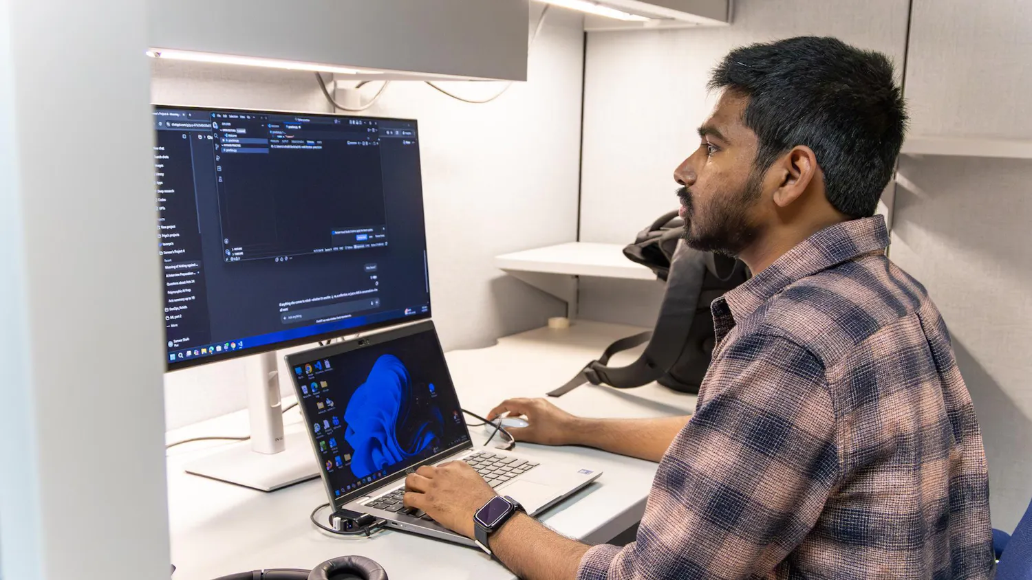 Sameer Shaik, an artificial intelligence analyst, looks at his computer in his cubicle in Gainesville, Fla., Friday, April 3, 2026.