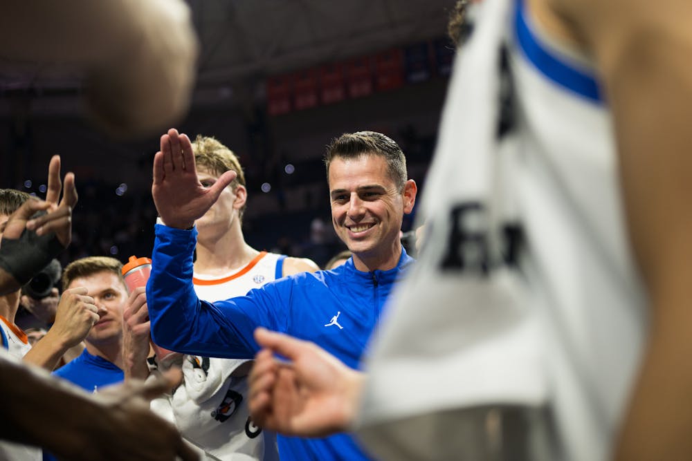 Florida Gators Head Coach Todd Golden celebrates with the team after a win in a basketball game against Oklahoma on Tuesday, Feb. 18, 2025, in Gainesville, Fla.