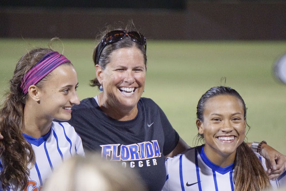 UF coach Becky Burleigh celebrates with her team follow a 4-0 win against Arkansas on Oct. 25, 2015, at Donald R. Dizney Stadium.