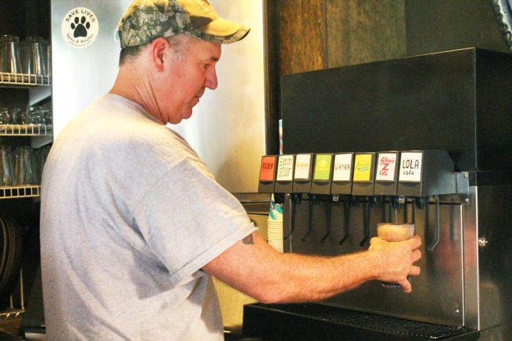 Satchel Raye, owner of Satchel’s Pizza, prepares a zero-calorie, stevia-sweetened drink, Stevie Z Cal, on Wednesday afternoon.
