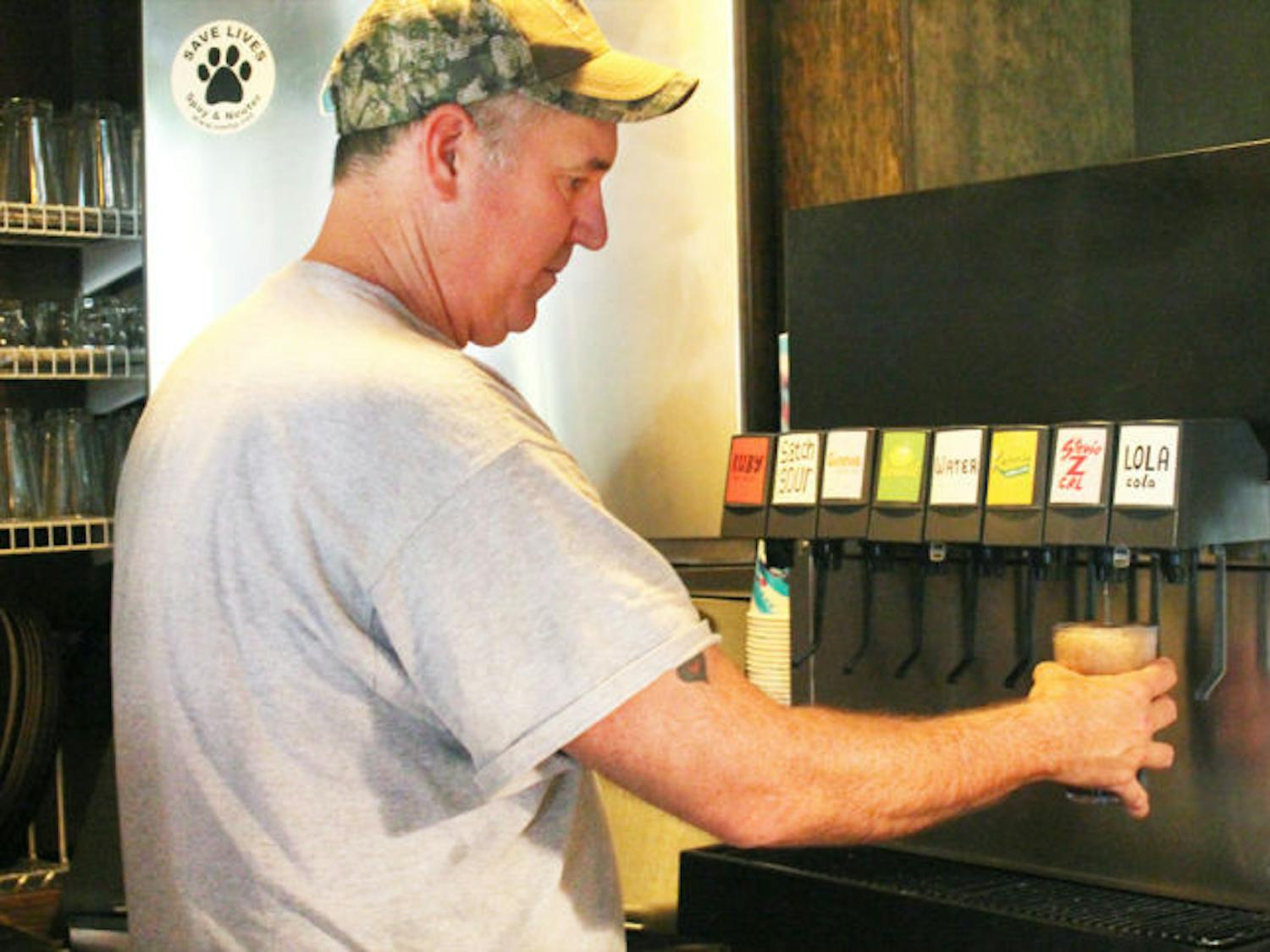 Satchel Raye, owner of Satchel’s Pizza, prepares a zero-calorie, stevia-sweetened drink, Stevie Z Cal, on Wednesday afternoon.