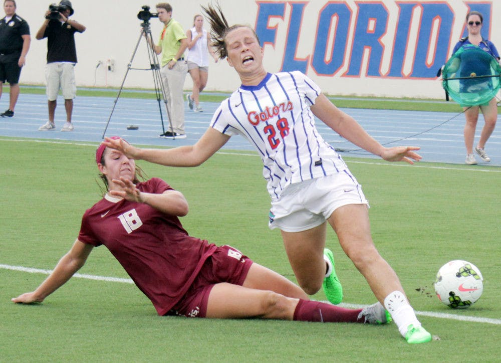 <p>UF midfielder Meggie Dougherty-Howard screams as her leg is hit by an FSU defender during Florida's 3-2 win on Aug. 30, 2015, at James G. Pressly Stadium. Dougherty-Howard returned to the game.</p>