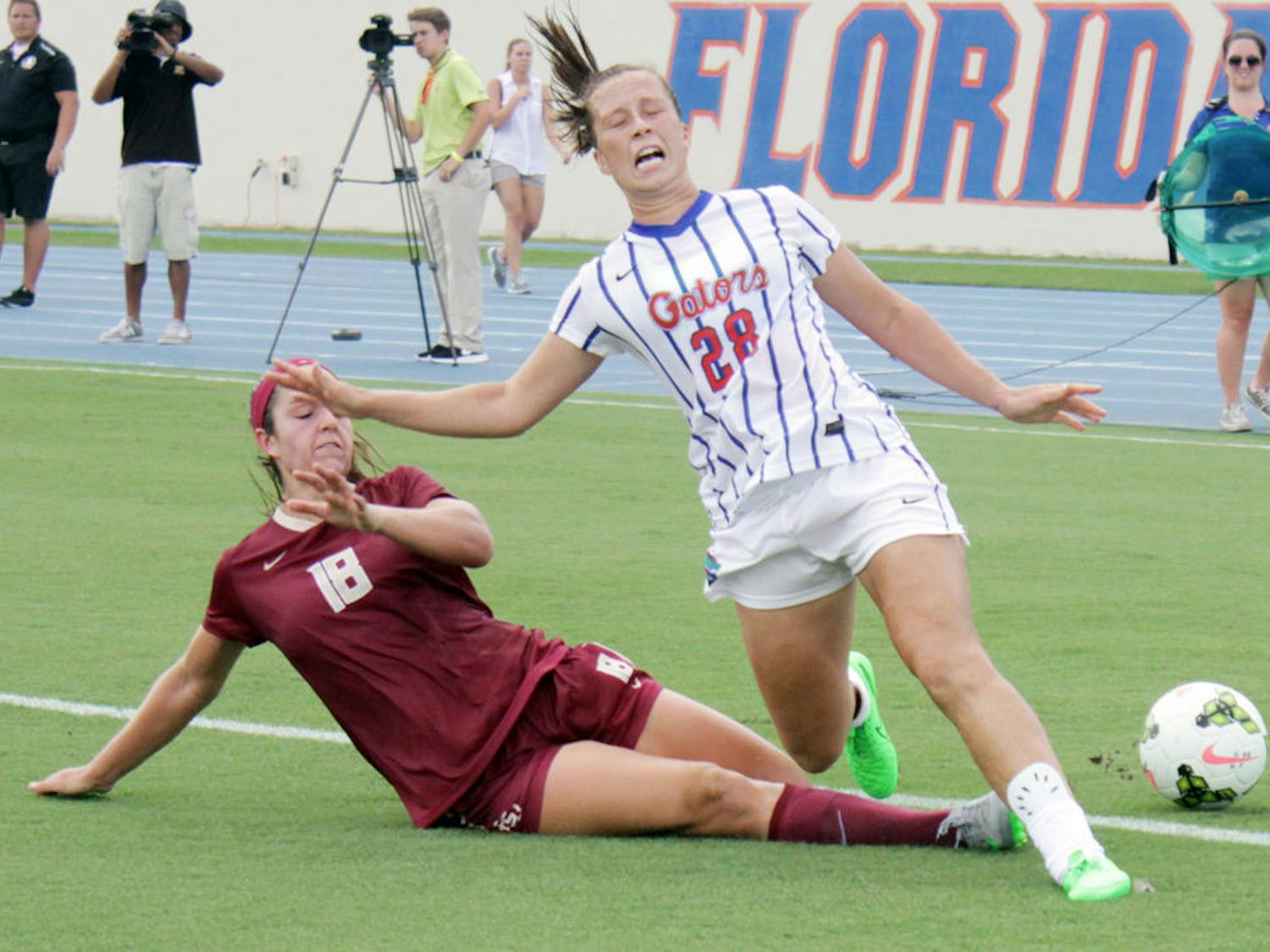 UF midfielder Meggie Dougherty-Howard screams as her leg is hit by an FSU defender during Florida's 3-2 win on Aug. 30, 2015, at James G. Pressly Stadium. Dougherty-Howard returned to the game.