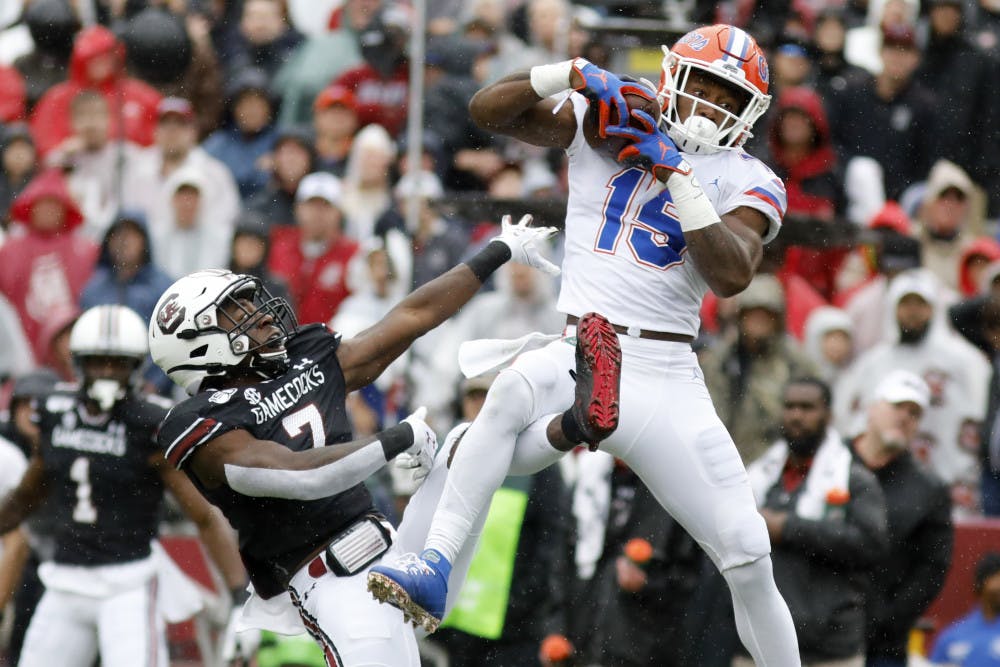 <p>Florida's Jacob Copeland (15) catches a pass for a touchdown as South Carolina's Jammie Robinson (7) defends in the first half of an NCAA college football game Saturday, Oct. 19, 2019, in Columbia, SC.</p>