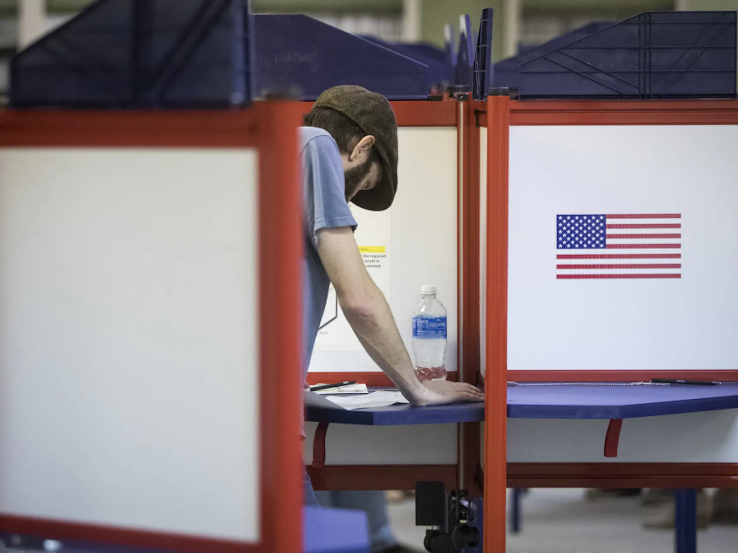 A voter reads his ballot at the Hamilton County Board of Elections as early voting begins statewide, Wednesday, Oct. 12, 2016, in Cincinnati.