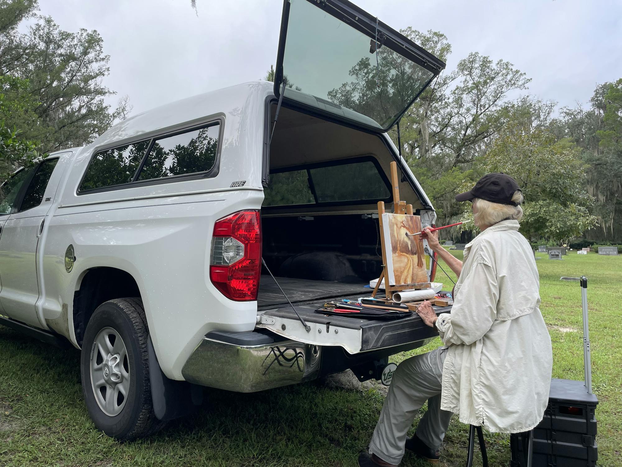 Professional artist Karen Miller, 77, begins painting in plein air at Evergreen Cemetery during the Art of Death event Oct. 10.