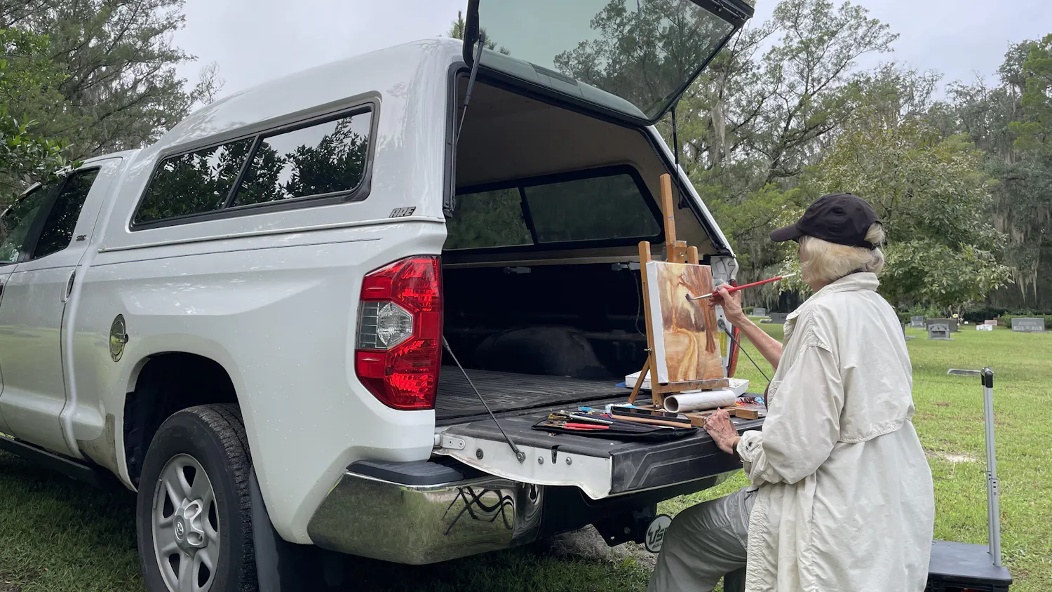Professional artist Karen Miller, 77, begins painting in plein air at Evergreen Cemetery during the Art of Death event Oct. 10.
