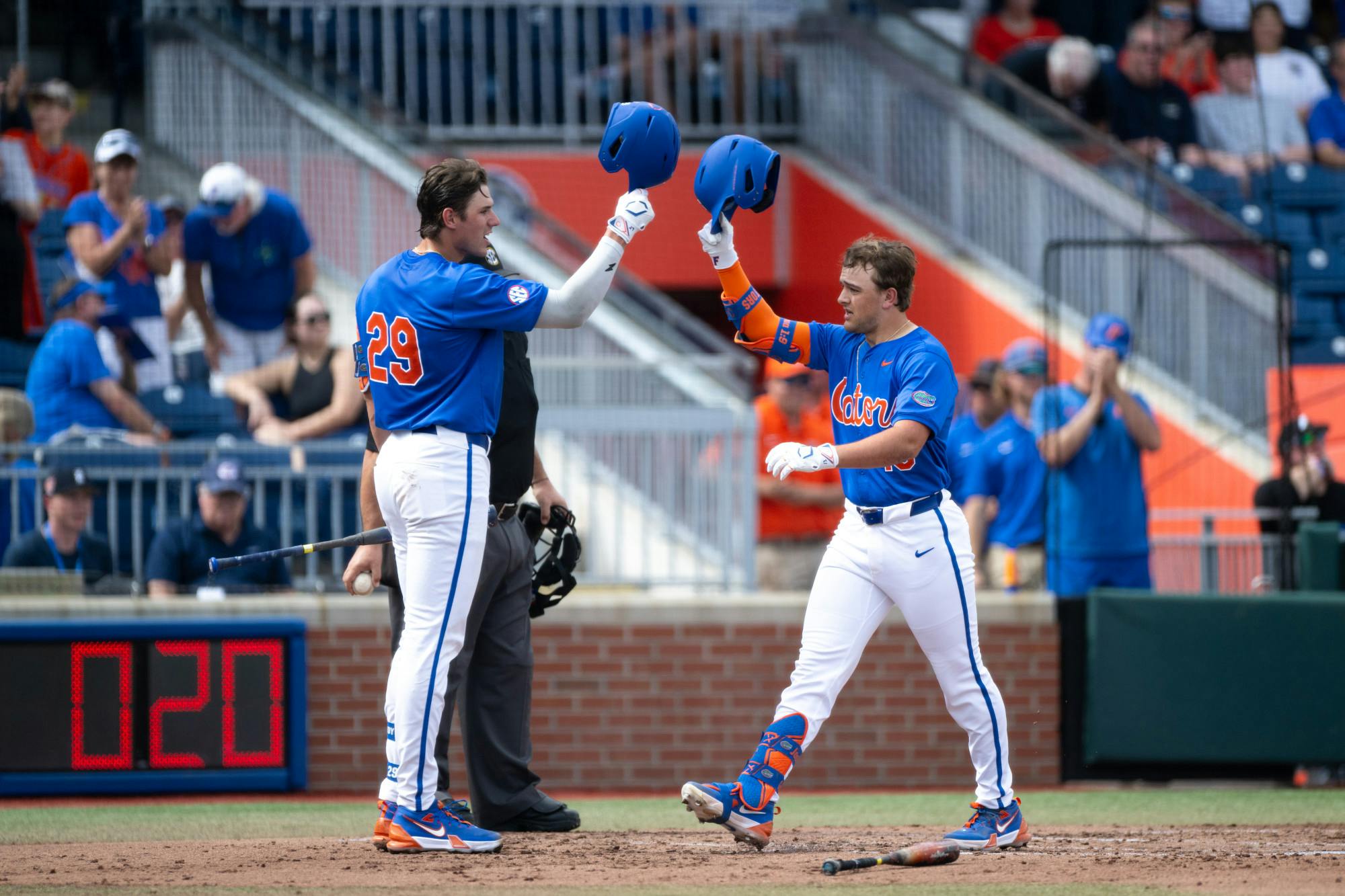 Florida Gators infielder Landon Stripling (13) helmet taps with teammate Brody Donay (29) after hitting his first home run of the season.