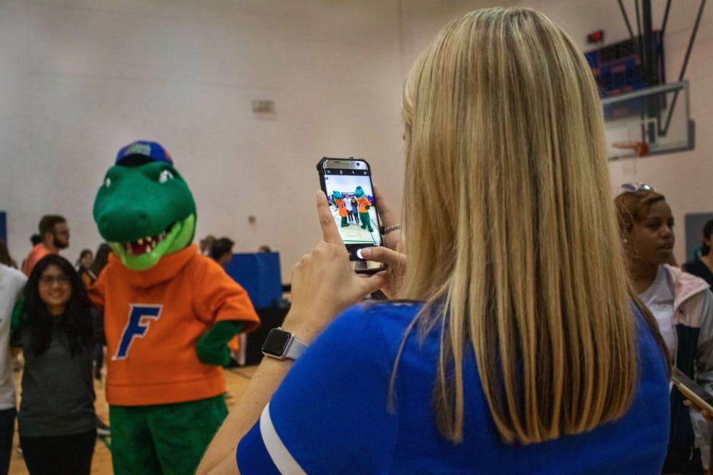 Students take a picture with Albert and Alberta Thursday evening during RecStravaganza at the Southwest Recreation Center. The event was hosted by RecSports and featured free T-shirts, games and pizza. The RecStravaganza was organized to get students interested in clubs, resources and RecSports intramurals.&nbsp;
