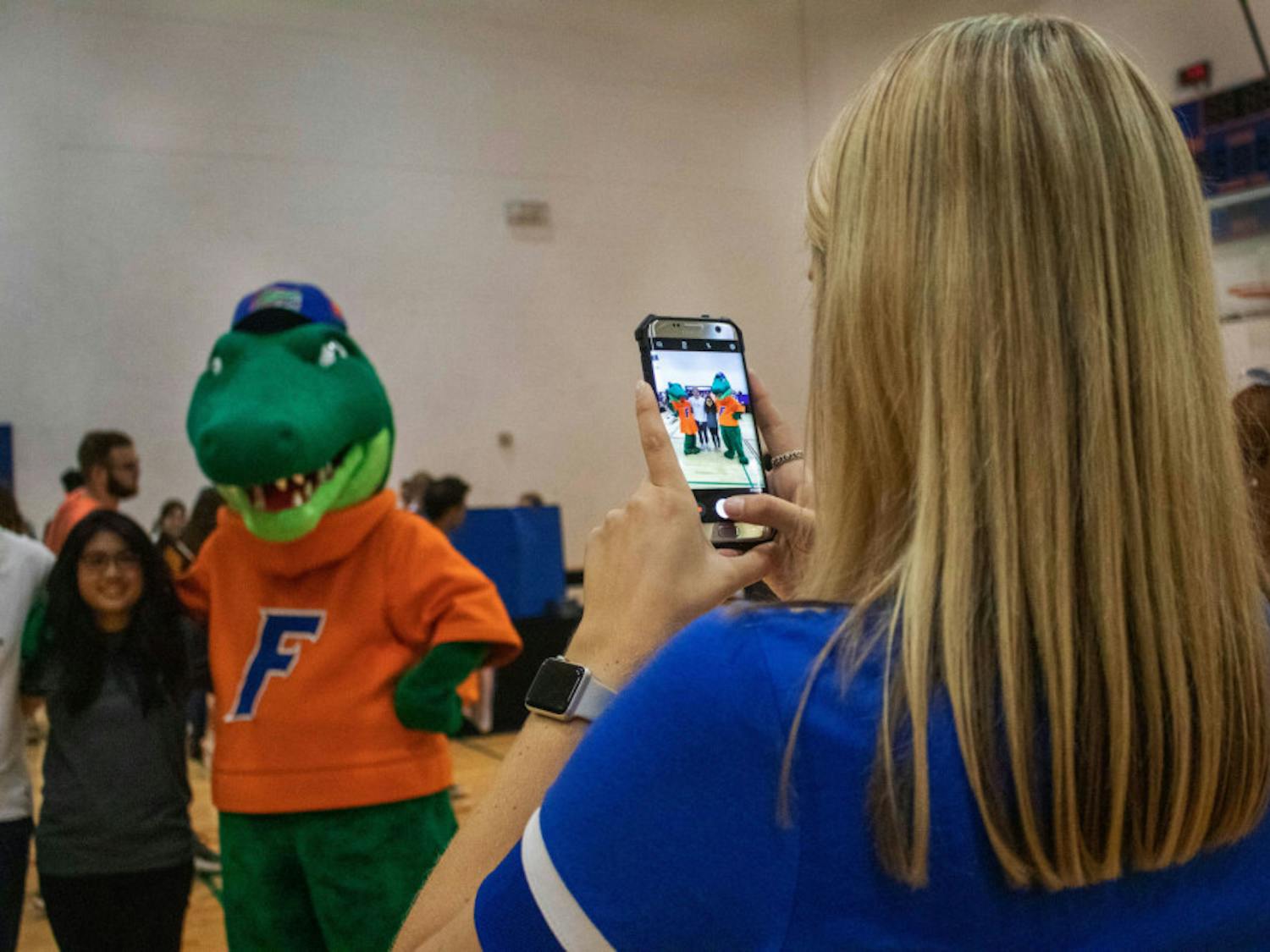 Students take a picture with Albert and Alberta Thursday evening during RecStravaganza at the Southwest Recreation Center. The event was hosted by RecSports and featured free T-shirts, games and pizza. The RecStravaganza was organized to get students interested in clubs, resources and RecSports intramurals. 