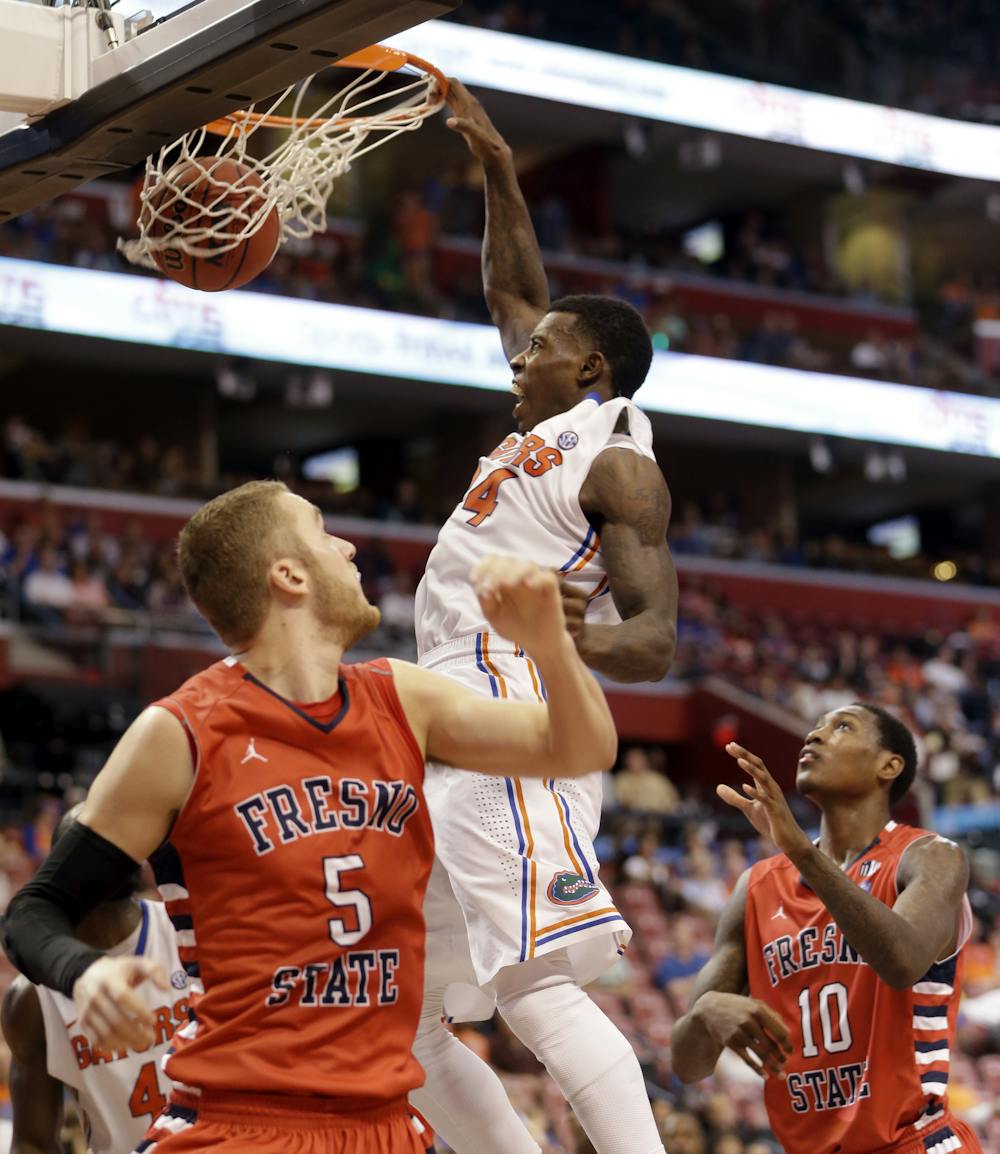 <p>Casey Prather (24) scores against Fresno State's Tanner Giddings (5) and Alex Davis (10) during No. 16 Florida's 66-49 win at the Orange Bowl Basketball Classic on Dec. 21 in Sunrise.</p>