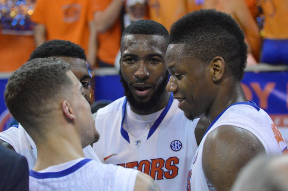 <p>Scottie Wilbekin, Casey Prather, Patric Young and Will Yeguete huddle together after Florida’s 84-65 win against Kentucky on Saturday in the O’Connell Center. The Gators are the first team to finish their Southeastern Conference regular-season schedule 18-0.</p>