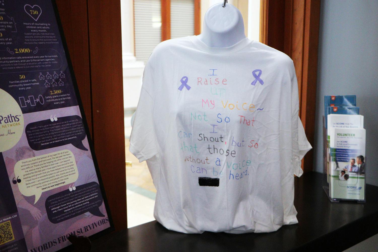 A Clothesline project display located in the Gainesville Chamber of Commercefeatures a shirt created by a domestic abuse survivor and an infographic that explains how to get help Wednesday, Oct. 26, 2022.
