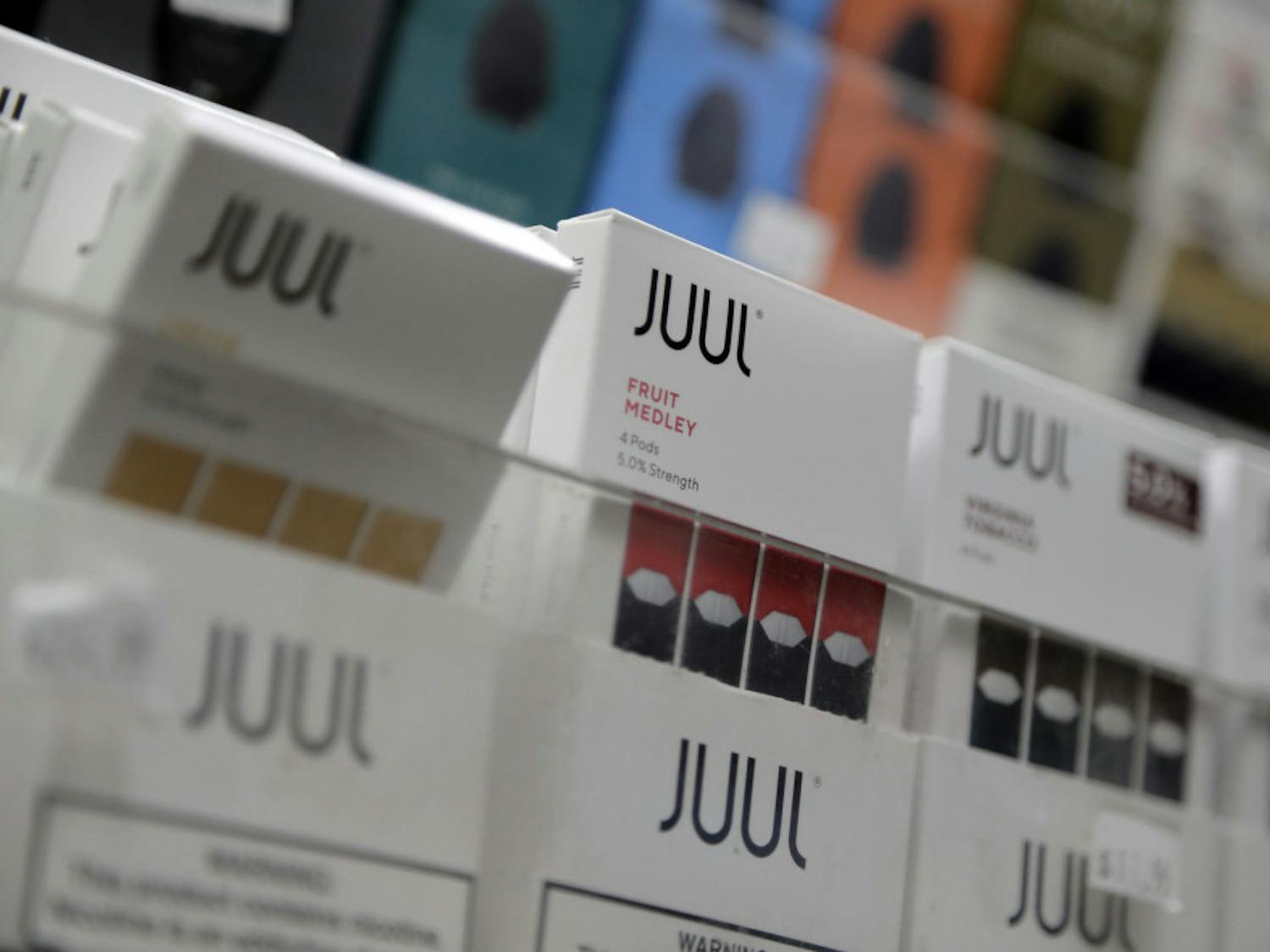 FILE - In this Dec. 20, 2018, file photo Juul products are displayed at a smoke shop in New York. Altria swung to a loss in the third quarter as it wrote down the value of its investment in e-cigarette maker Juul. Altria bought roughly a third of Juul for $13 billion last December. Since then, an outbreak of vaping illnesses - some deadly - has led to multiple investigations, with Juul no longer advertising its products in the U.S. (AP Photo/Seth Wenig, File)