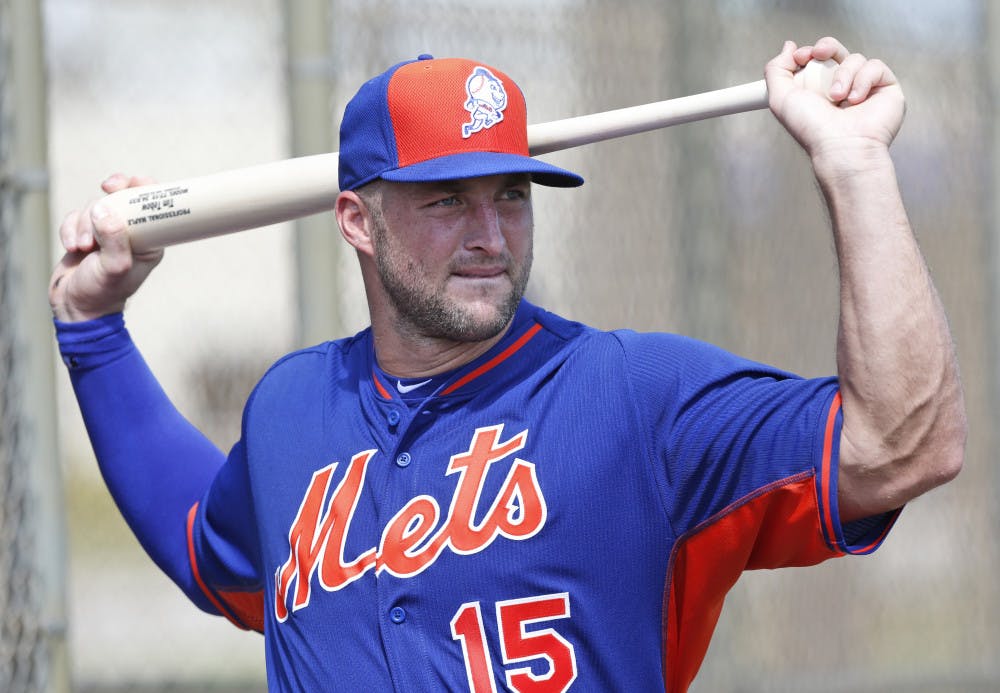Tim Tebow stretches out before batting practice at the New York Mets' complex, Monday, Sept. 19, 2016, in Port St. Lucie, Fla. The 2007 Heisman Trophy winner and former NFL quarterback got to the complex early Monday, and started his first workout as part of their instructional league team.