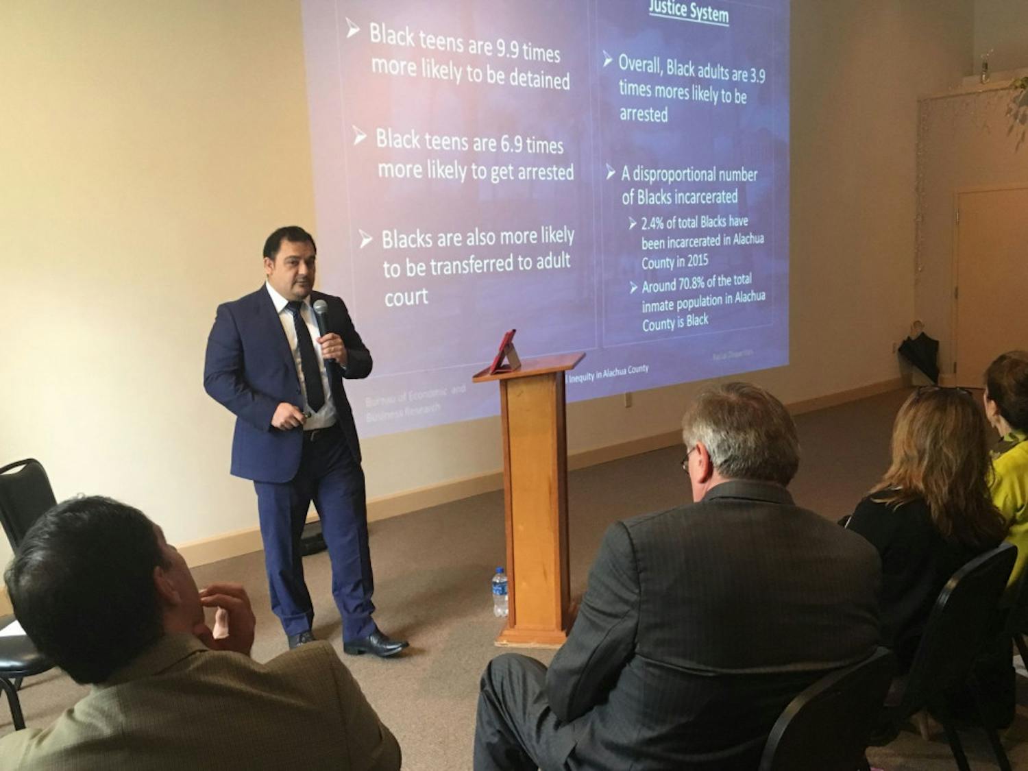 UF assistant professor Hector Hugo Sandoval Gutierrez presents data on racial inequity within the county to an audience of more than 200 Friday afternoon at the Mt. Moriah Missionary Baptist Church, located at 718 SE 11th St.