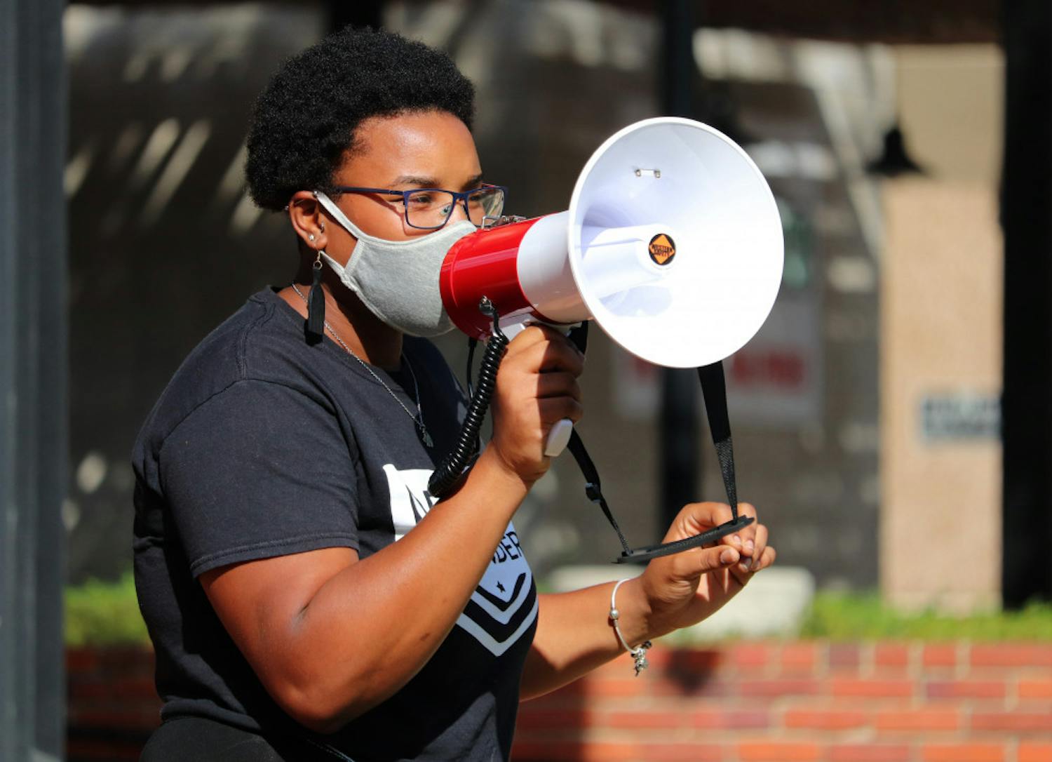 Kiara Laurent speaks to the crowd at Bo Diddley Plaza in Gainesville before protesters march to the Alachua County Courthouse on Saturday, Sept. 26, 2020. Laurent is a member of the Dream Defenders, a black-led organization of young people who planned this event. (Lauren Witte/Alligator Staff)