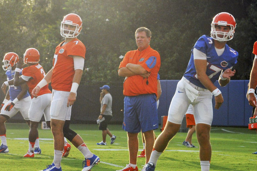 <p>UF coach Jim McElwain (center) watches on as quarterbacks Will Grier (7) and Anderson Proctor (17) go through drills during practice on Aug. 31, 2015, at the Sanders Practice Field.</p>