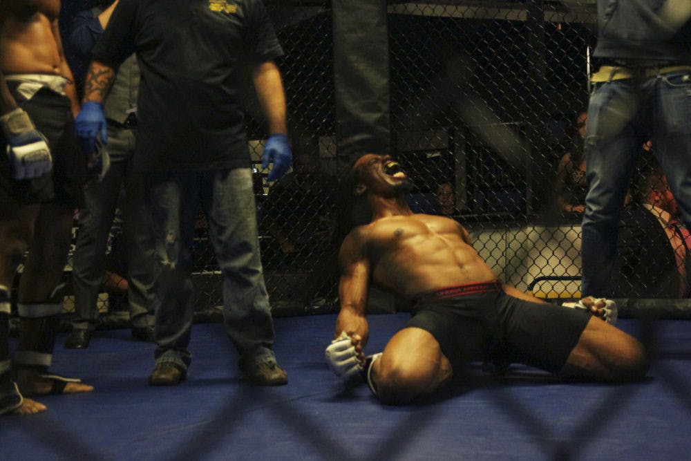 Garrick James celebrates his victory over Lorenzo Hunt at “Friday Night Lights,” an MMA event hosted at Level Nightclub on Friday night. James earned the title of middleweight champion.