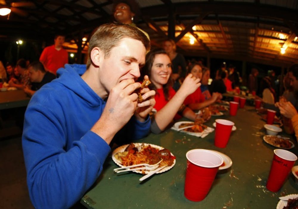 <p>Civil engineering major Kyle Mays, 19, eats a piece of fried quail at the 29th annual Beast Feast on Saturday night. The event was sponsored by the UF Wildlife Society.</p>