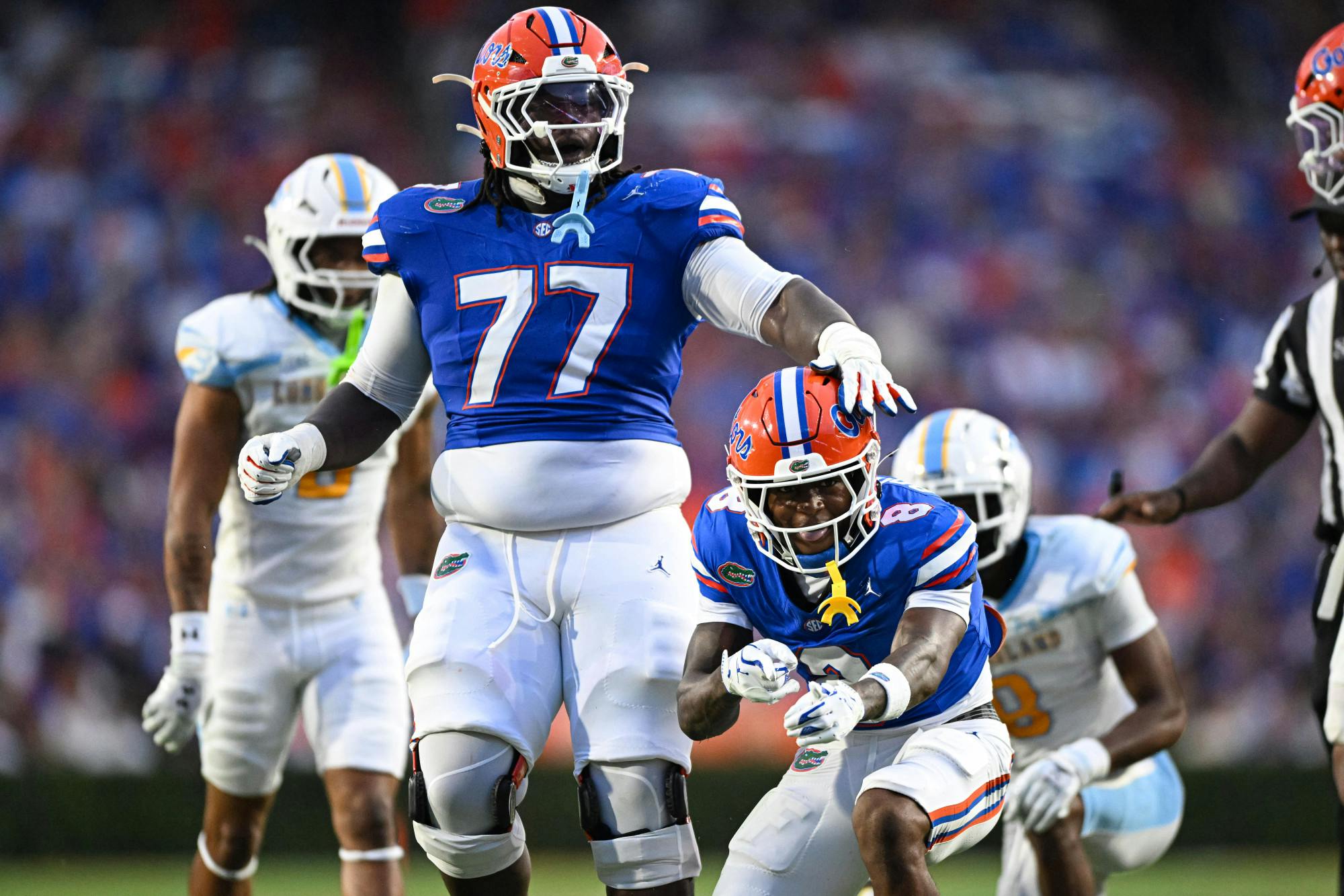 Florida Gators wide receiver Vernell Brown III (8) and offensive lineman Knijeah Harris (77) celebrate a play during a football game between the Long Island Sharks and the Florida Gators on Saturday, Aug. 30, 2025, at Ben Hill Griffin Stadium in Gainesville, Fla.